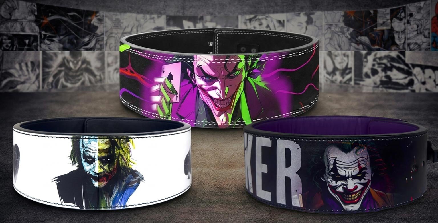 Three custom weightlifting belts displaying various Joker themes, featuring a neon purple and green animated Joker holding a playing card, a white belt with a split-face movie portrait, and a dark belt with a smiling Joker graphic and distressed text.