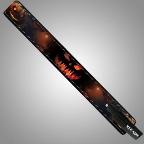 Full view of a Halloween weightlifting belt with a glowing orange pumpkin face, dark branches, and a personalized lever buckle.