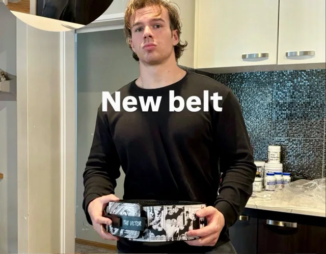 Customer holding a custom black-and-white manga weightlifting belt.
