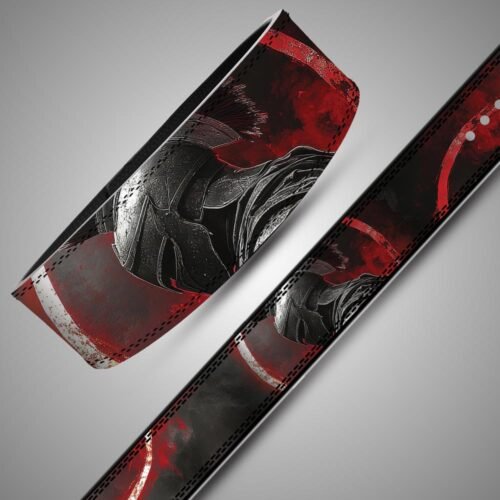 Angled close-up and flat strap view of a Spartan helmet lifting belt with distressed red and white circular patterns